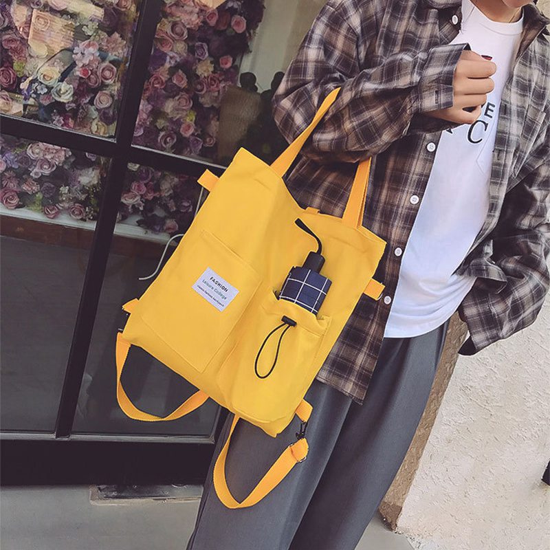 حقيبة يد قماشية بنمط "هاراجوكو" للطلاب مزودة بجيوب، مناسبة للطراز الأكاديمي (Preppy Style)، وتصلح كحقيبة كتف أو حقيبة مدرسية للنساء. - الصورة 3